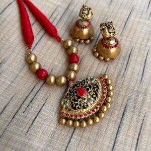 Red and gold terracotta pendant set with peacock jhumkas
